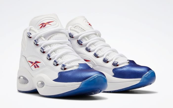 View of white and blue Reebok shoes.